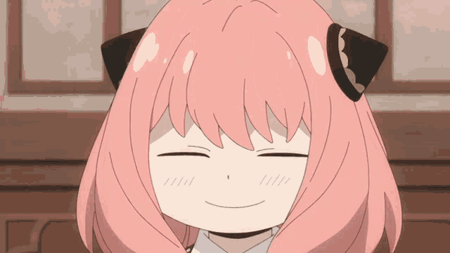 a cartoon girl with pink hair and black ears is smiling