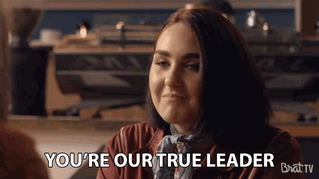 a woman says " you 're our true leader " while sitting at a table
