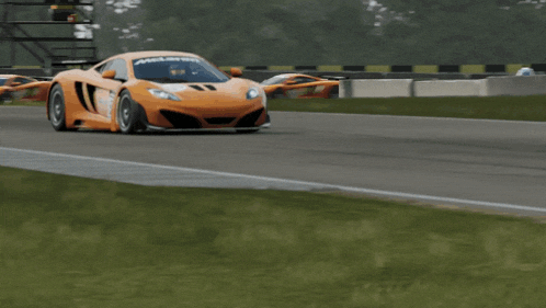 a mclaren race car is driving down a race track