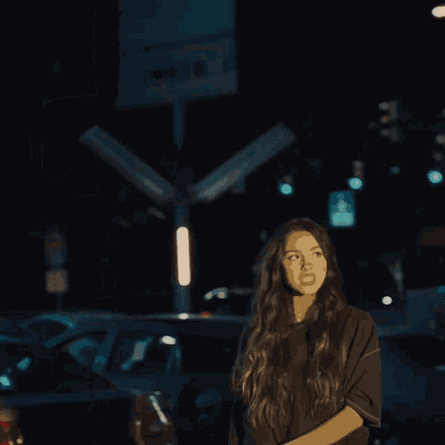 a woman in a black shirt is standing in front of a sign that says walk 1