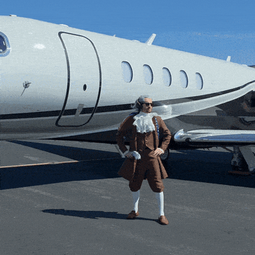 a man standing in front of a white airplane