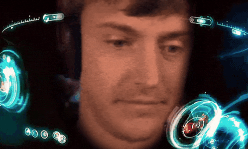 a close up of a man 's face with a screen behind him that says ' a ' on it