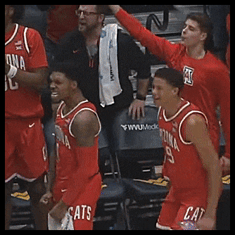 a group of basketball players wearing red uniforms with cats on them