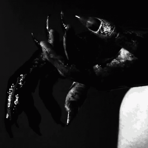 a black and white photo of a monster 's hands