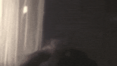 a woman smoking a cigarette in a dark room