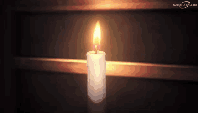 a lit candle in a dark room with naruto-base.ru written on the bottom