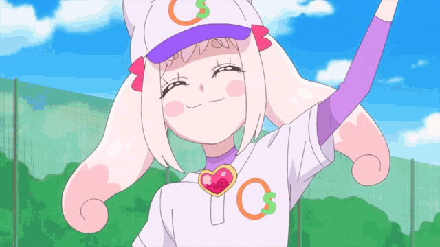 a girl wearing a baseball cap with the letter c on it is smiling