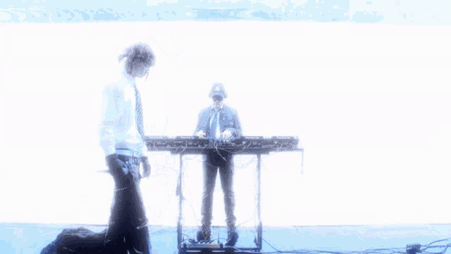 a man in a tie is playing a keyboard in front of a blue background