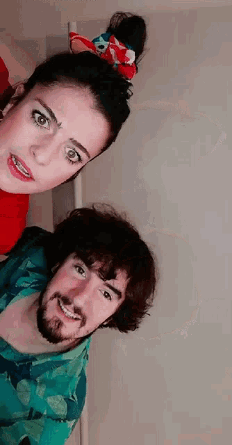 a man and a woman are posing for a picture together and the woman has braces on her teeth