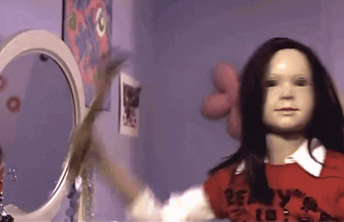a doll wearing a red shirt that says ready
