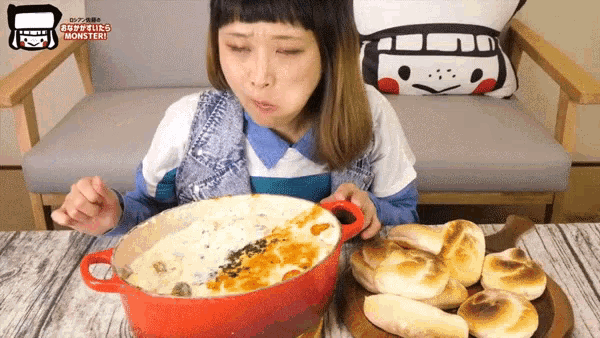 a woman is eating a pot of food with the word monster on the bottom