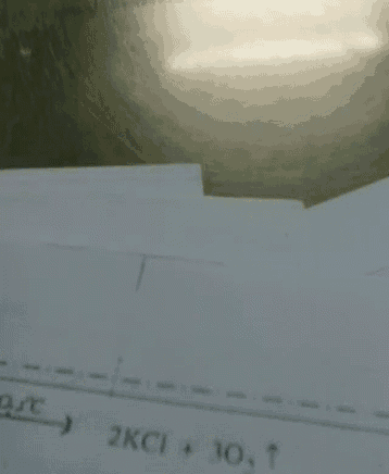 a piece of paper with a line on it that says 2kci + 10 t on it .