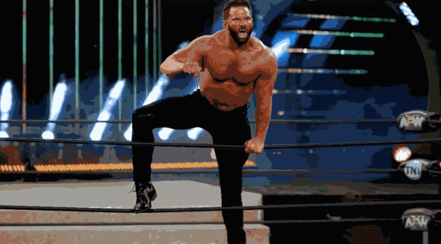 a wrestler in a ring with the word aew on the ropes