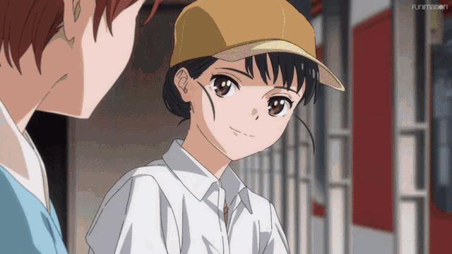 a girl in a baseball cap is talking to another girl in a white shirt