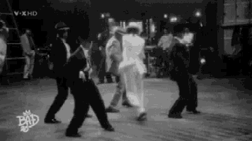 a group of people are dancing in a black and white photo with the words bad on the bottom
