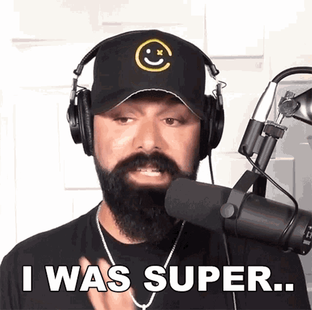 a man with a beard wearing headphones says i was super