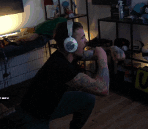 a man wearing headphones is squatting down