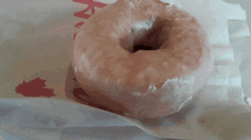a close up of a donut on a piece of paper that says k