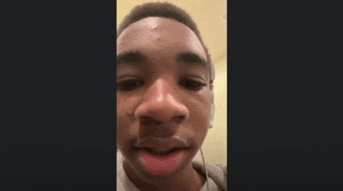 a young man is wearing headphones and making a funny face