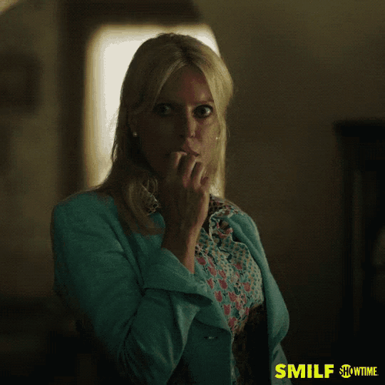 a woman biting her nails with a showtime advertisement behind her