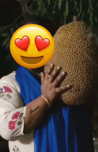 a woman with a smiley face on her face holding a large fruit