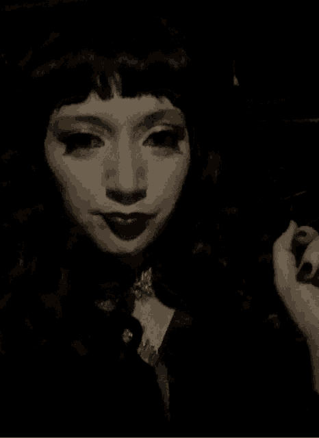 a woman with a ring on her finger is making a peace sign
