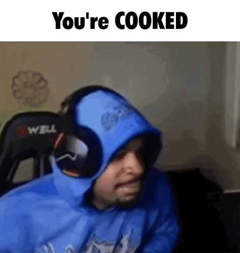 a man wearing headphones and a blue hoodie with the words `` you 're cooked '' written on it .