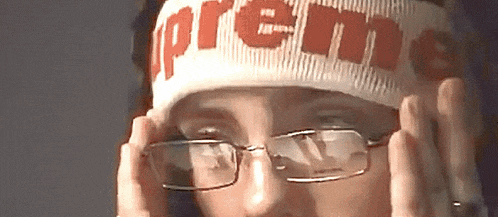 a person wearing a headband that says supreme on it