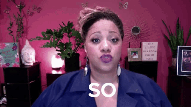 a woman in a blue jacket with the word so on her chest