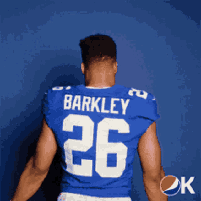 a man wearing a blue nike jersey with the letter k on the back