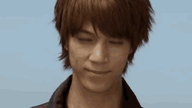 a close up of a young man 's face with brown hair