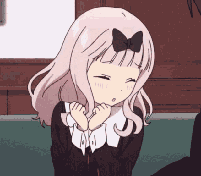 a girl with a bow on her head is sitting on a couch