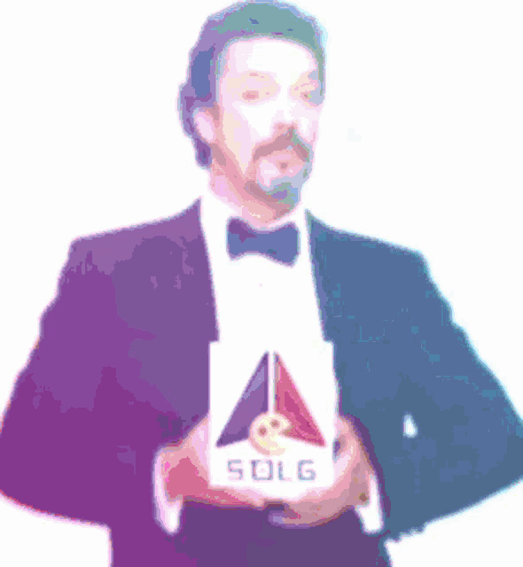 a man in a tuxedo holds a sign that says sdlg
