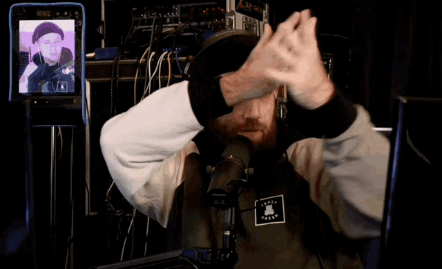 a man wearing headphones and a shirt with a bear logo on it