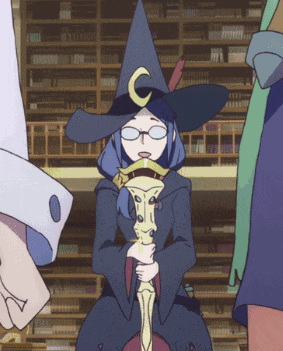 a witch with a crescent moon on her hat is holding a wand
