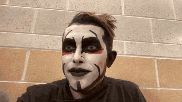 a man with his face painted in black and white