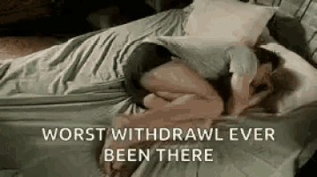 a man and a woman are laying on a bed .