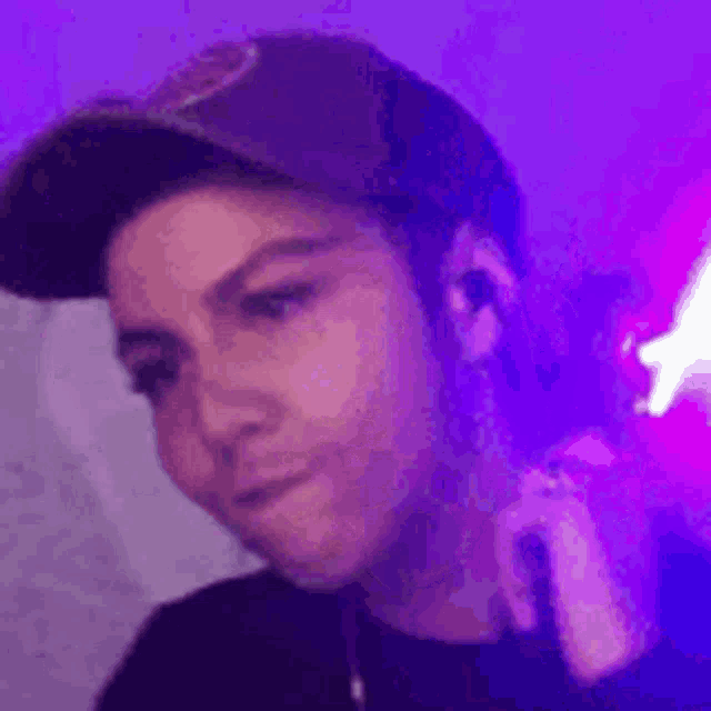 a close up of a person wearing a hat and earbuds .