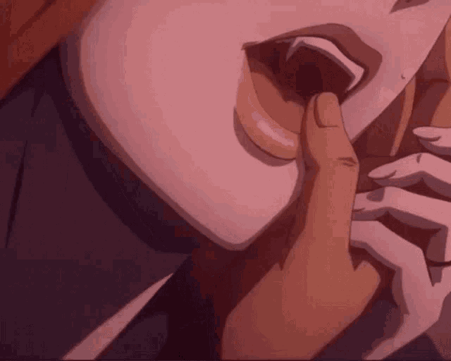a close up of a person 's mouth with a finger in it