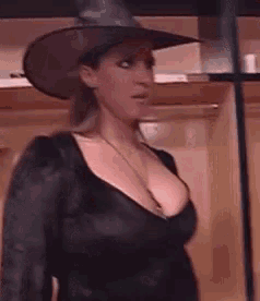 a woman is wearing a witch hat and a black top
