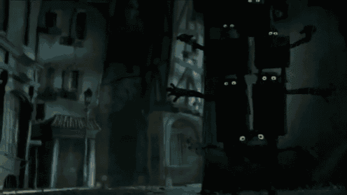 a group of black boxes with yellow eyes are hanging from the ceiling in a dark room
