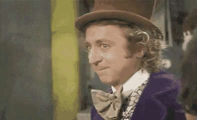 a man wearing a top hat and a bow tie is smiling .