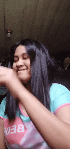 a girl with long black hair is wearing a shirt with the word beor on it