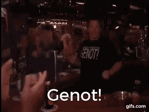 a man is standing at a bar with his arms outstretched in front of a crowd of people .