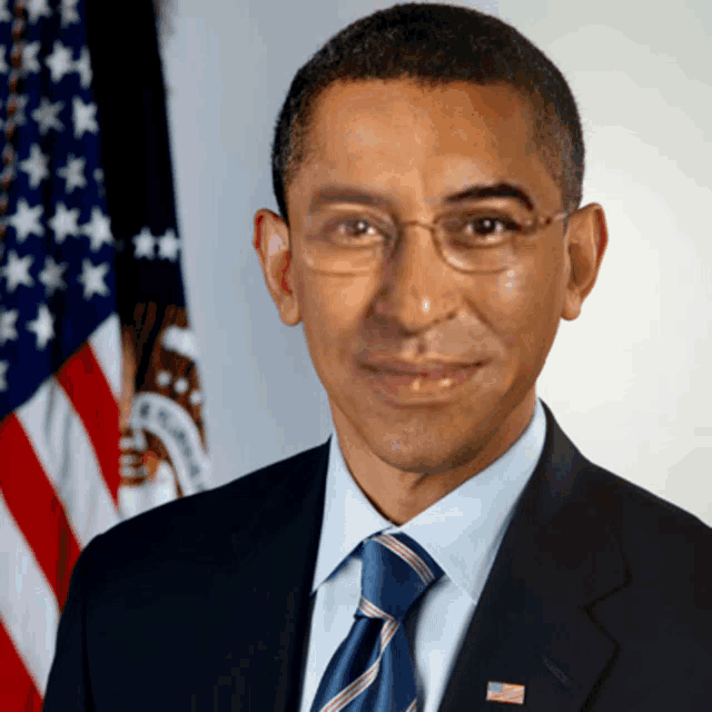 a man in a suit and tie with an american flag on his jacket