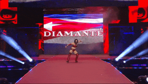 a woman is dancing on a stage in front of a large screen that says " diamante "