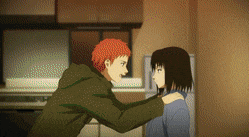 a man and a woman are hugging each other in a kitchen