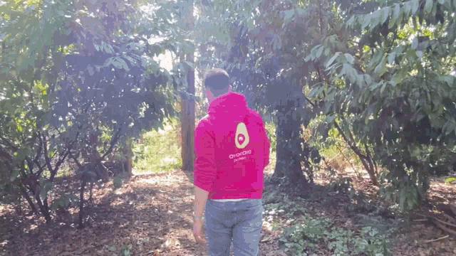 a man in a red hoodie with an avocado on the back