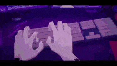 a person 's hands are typing on a keyboard in a dark room .