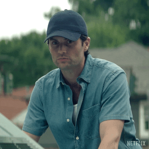 a man wearing a blue hat and a denim shirt with netflix on the bottom